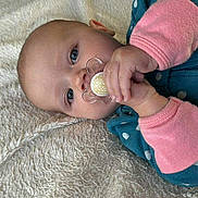 Everleigh Janis Mae is registered to the contest to win money with this photo: baby, pacifier, blue_eyes, polka_dot, pink_cuffs, teal_outfit, blanket, soft_texture, infant, close_up, cute, child, hand, face, lying_down, cozy, indoors, sleepwear, newborn, portrait