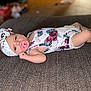baby, child, closeup, cute, fabric, floral_outfit, headband, indoor, infant, lying_down, newborn, pacifier, peaceful, person, portrait, resting, skin, small_arms, small_legs, soft_focus