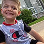 Zavian joined the competition — help win amazing prizes! child, boy, smiling, outdoor, tshirt, shorts, grass, house, sidewalk, greenery, happy, portrait, casual, daylight, person, short_hair, sitting, nature, sunlight, cheerful