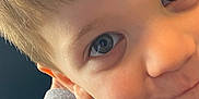Zavian is registered to the contest to win money with this photo: child, face, close_up, blue_eyes, smile, hair, skin, sleeve, clothing, playful, portrait, young, casual, expression, indoor, person, cute, head, eyebrows, eyelashes