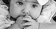 Taverly-Rose joined the competition — help win amazing prizes! baby, infant, child, face, hands, bow, headband, black_and_white, portrait, close_up, expression, clothing, fabric, cute, young, sitting, person, soft_texture, curious, eyes