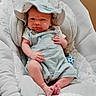baby, baby_seat, child, clothing, comfortable, cushion, cute, expression, hat, headwear, indoor, infant, light_blue, newborn, overalls, person, portrait, resting, small_feet, wood_floor