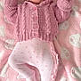 Ruby is registered to the contest to win money with this photo: baby, infant, pink, blanket, knitted_sweater, footed_pants, cute, sleepy, soft_texture, toddler, child, lying_down, pattern, bear_faces, warm_clothing, indoors, portrait, cozy, small_hands, peaceful