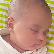 Ruby joined the competition — help win amazing prizes! baby, sleeping, face, infant, child, onesie, clothing, cute, chubby_cheeks, peaceful, resting, closeup, portrait, head, skin, newborn, striped_background, yellow, white, soft