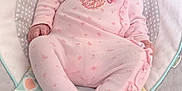 Ruby is registered to the contest to win money with this photo: baby, infant, onesie, pink_clothing, baby_rocker, plush_toy, soft_toy, flooring, patterned_fabric, child, cute, sleepwear, comfort, indoor, newborn, infant_fashion, seated, portrait, baby_girl, relaxed