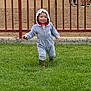 toddler, child, grass, greenery, hoodie, onesie, boots, outdoor, fence, people, smile, happy, walking, baby, casual_clothing, daytime, park, playful, cute, fun