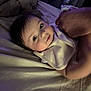 Zavier joined the competition — help win amazing prizes! baby, infant, face, hands, bed, blanket, bedding, bib, person, skin, sleepwear, indoor, portrait, child, cute, young, lying_down, holding, soft_lighting, closeup