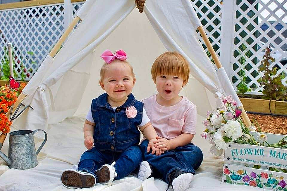 Abigal joined the competition — help win amazing prizes! baby, baby_toddler_clothing, child, dress, event, fence, floral_design, flower, grass, happy, hat, joy, people, person, photograph, pink, plant, sitting, smile, toddler
