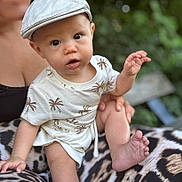 Sohan participe au concours pour gagner de l'argent avec cette photo : adult, baby, blurred_background, cap, child, clothing, cute, expression, foot, hand, hat, infant, legs, nature, outdoor, palm_tree_pattern, person, portrait, sitting, skin