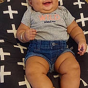 Anaya joined the competition — help win amazing prizes! baby, child, smile, headband, denim_shorts, cushion, patterned, indoor, happy, cute, chubby, skin, person, sitting, comfortable, apparel, casual, portrait, infant, home