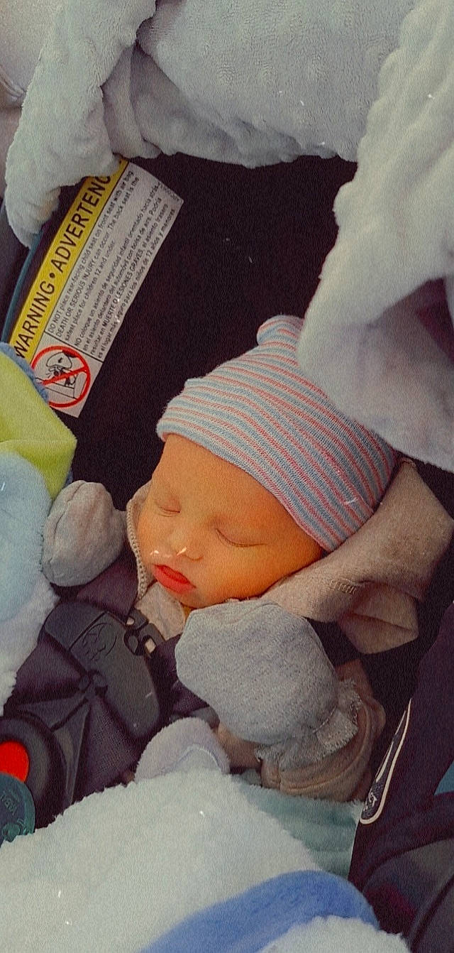 Prince is registered to the contest to win money with this photo: baby, baby_carriage, baby_products, baby_sleeping, baby_toddler_clothing, bedtime, cap, cheek, child, comfort, headgear, headwear, knit_cap, linens, mouth, nap, person, skin, sleeve, textile