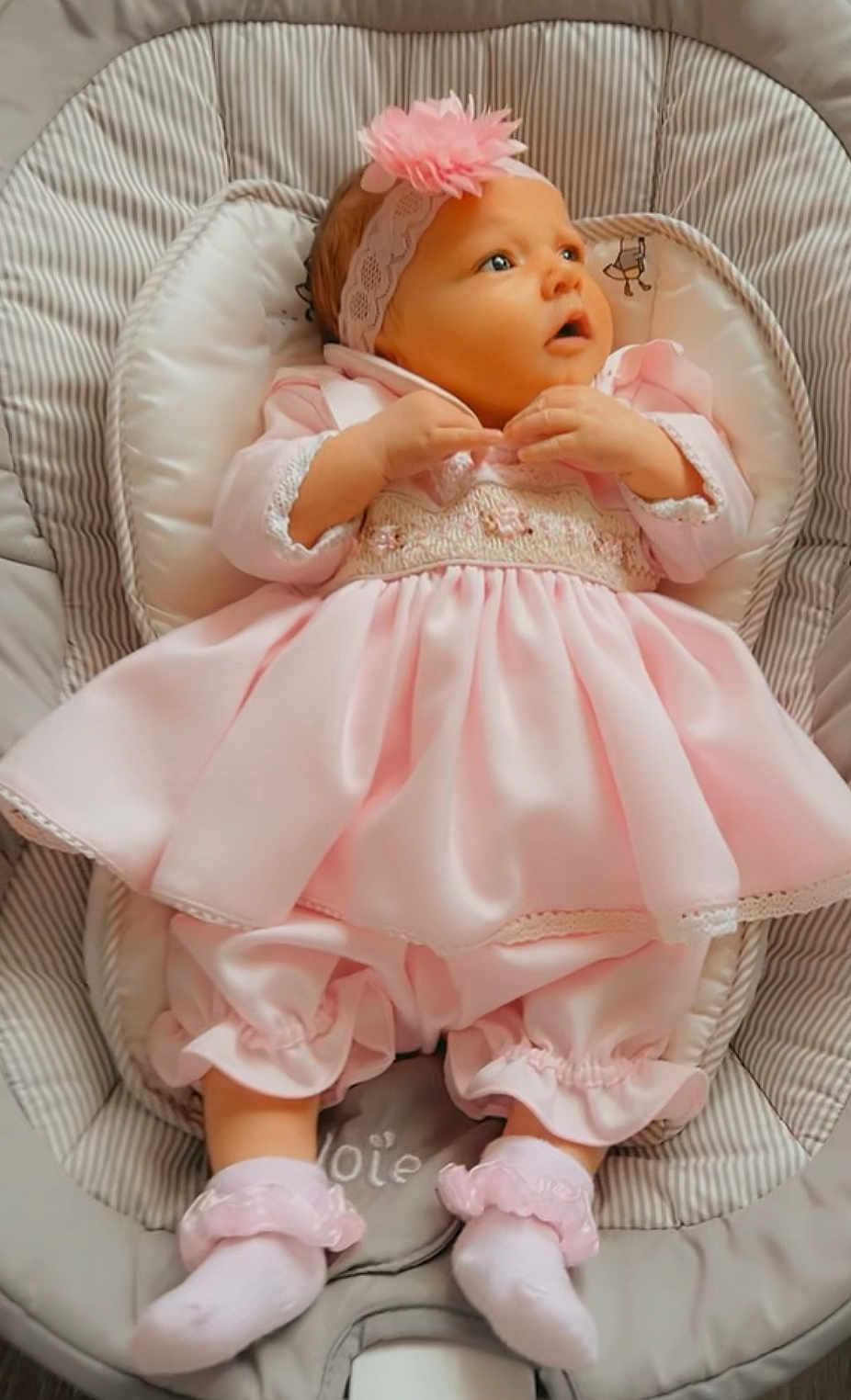 Alayiah-Sloan joined the competition — help win amazing prizes! baby, infant, pink_dress, headband, flower, baby_seat, cushion, socks, cute, child, apparel, portrait, indoors, comfort, soft_fabric, newborn, small_hands, small_feet, expression, resting