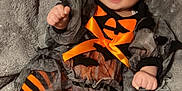 Alayiah-Sloan is registered to the contest to win money with this photo: baby, child, pumpkin, halloween_costume, orange, black, striped_tights, headband, bow, smile, happy, blanket, cute, festive, holiday, sitting, face, person, infant, cozy