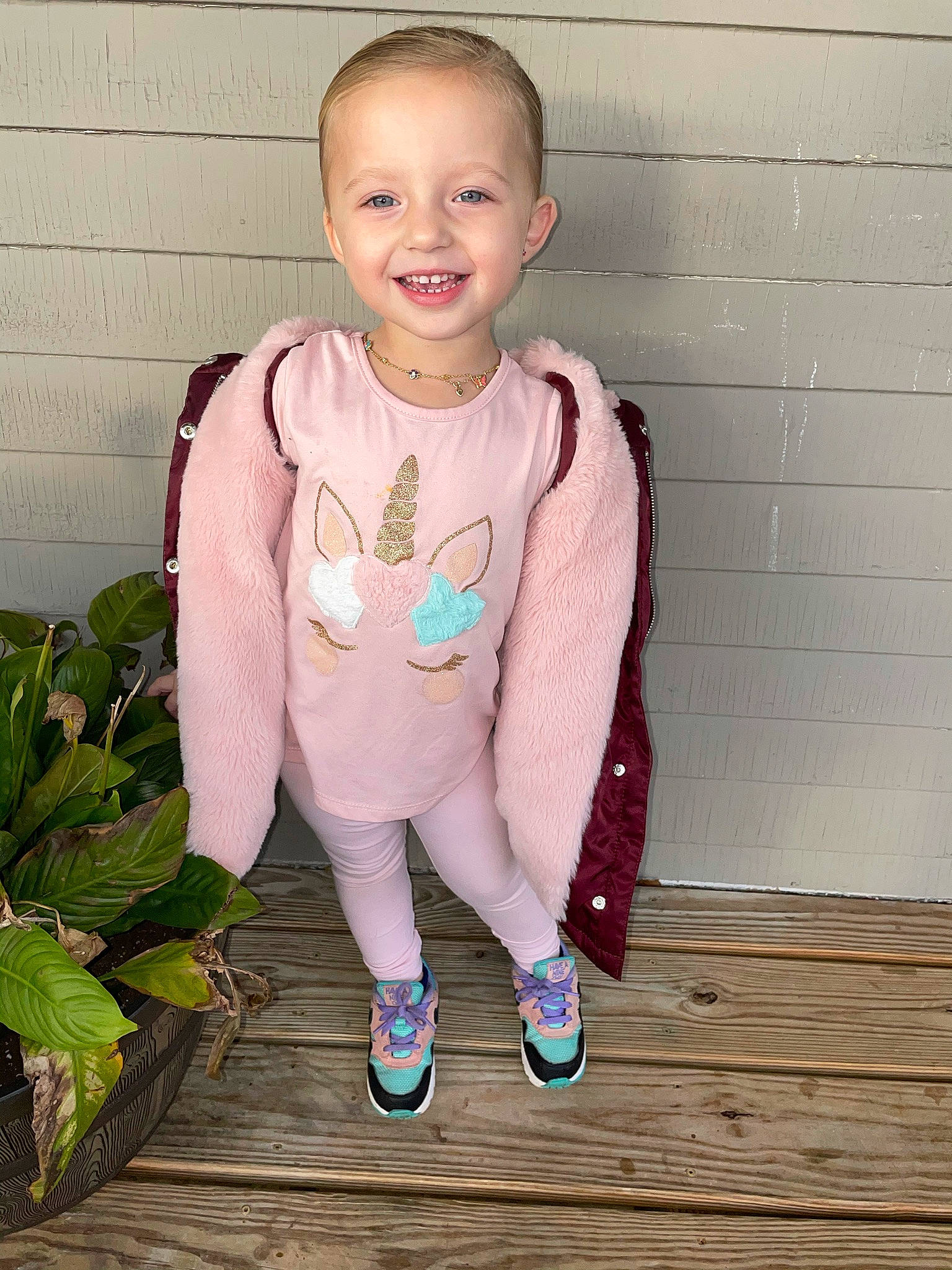 Analyse is registered to the contest to win money with this photo: child, child_model, clothing, costume, face, fashion_accessory, footwear, jacket, joy, neck, outerwear, person, pink, plant, shoe, sleeve, sportswear, standing, sweater, toddler