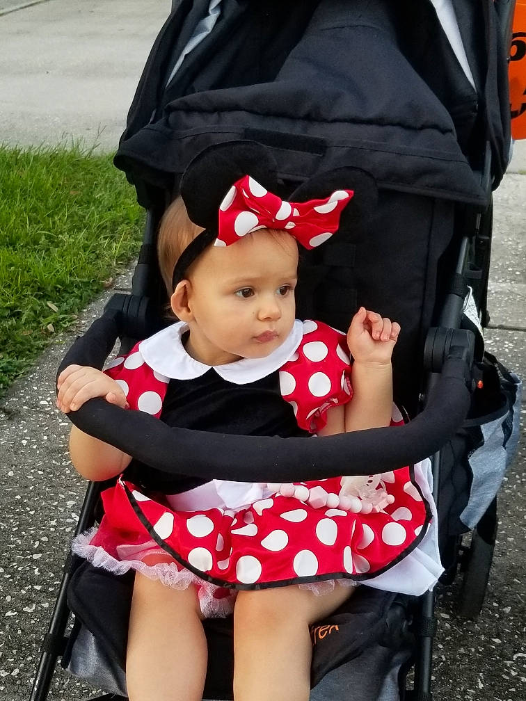 Adriana is registered to the contest to win money with this photo: baby, baby_carriage, baby_products, baby_toddler_clothing, chair, child, costume_hat, event, fashion_accessory, grass, hat, headwear, pattern, person, photograph, plant, product, recreation, sitting, toddler