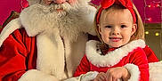 Emy participe au concours pour gagner de l'argent avec cette photo : child, santa_claus, christmas, holiday, festive_clothing, red_dress, white_fur_trim, girl, beard, glasses, smile, indoor, decorations, lights, headband, black_shoes, jeans, gloves, portrait, happy