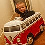 Ayden participe au concours pour gagner de l'argent avec cette photo : casual_clothing, child, cute, fun, hallway, happy, indoor, miniature_vehicle, person, playtime, red, smile, steering_wheel, toddler, toy_car, vehicle, waving, white, wooden_floor, young_child