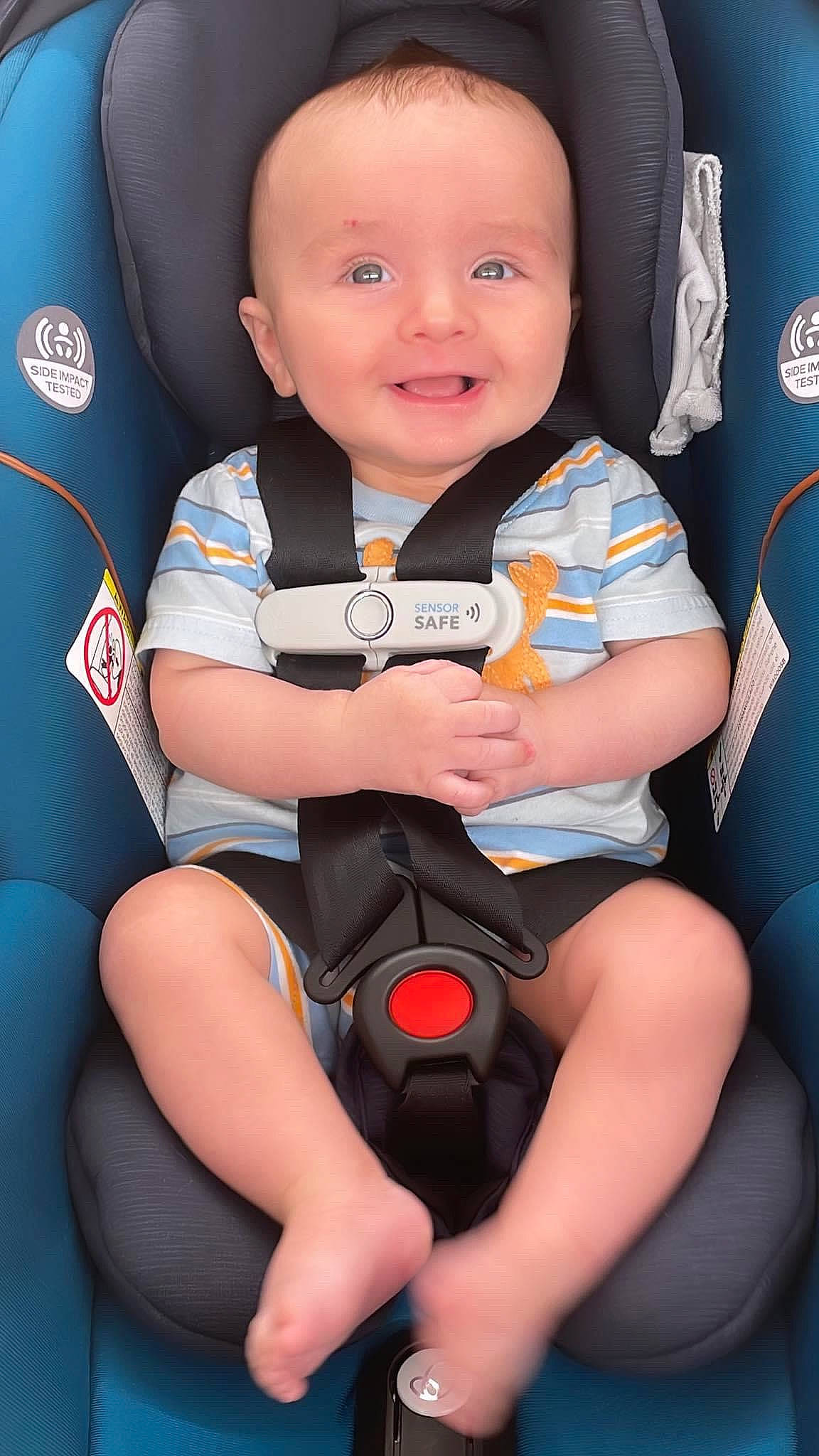 Jameson is registered to the contest to win money with this photo: arm, baby, baby_toddler_clothing, black, car_seat, child, comfort, electric_blue, fun, happy, human_leg, joy, lap, person, sitting, skin, sleeve, smile, thigh, toddler