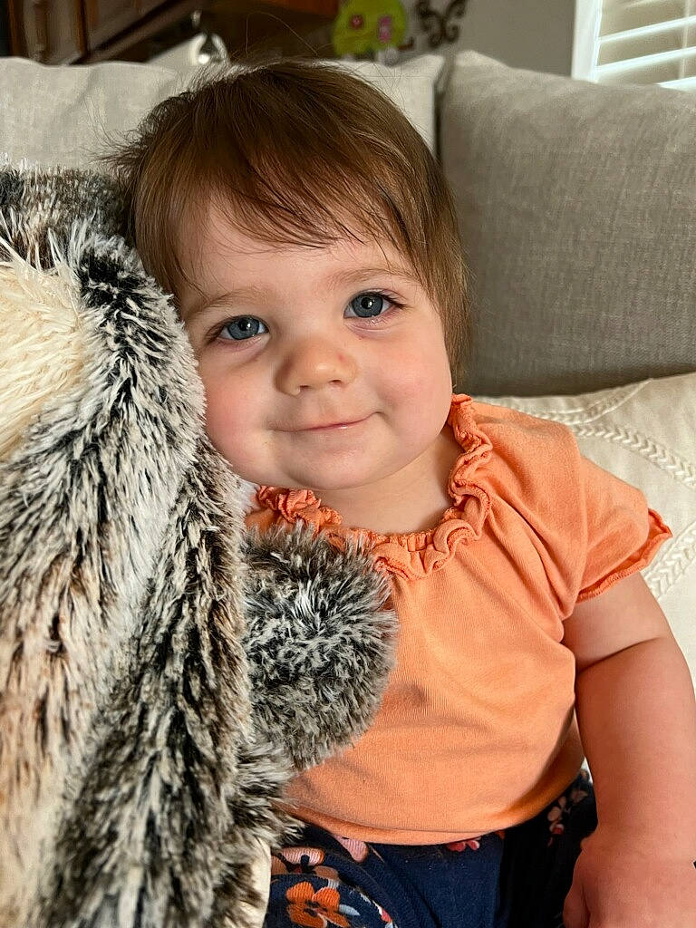 Elizabeth joined the competition — help win amazing prizes! child, couch, electric_blue, face, fashion_accessory, fun, fur, fur_clothing, hair, happy, head, joy, living_room, person, portrait_photography, sitting, skin, sleeve, smile, toddler