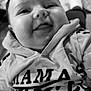 baby, child, smiling, hoodie, clothing, face, tongue, indoor, portrait, cute, chubby_cheeks, happy, person, infant, black_and_white, casual, cozy, young, closeup, expression