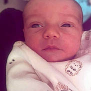 Jordan participe au concours pour gagner de l'argent avec cette photo : animal_print, baby, blanket, child, closeup, clothing, cute, face, indoors, infant, newborn, person, portrait, resting, skin, sleepy, soft, swaddled, warm, young