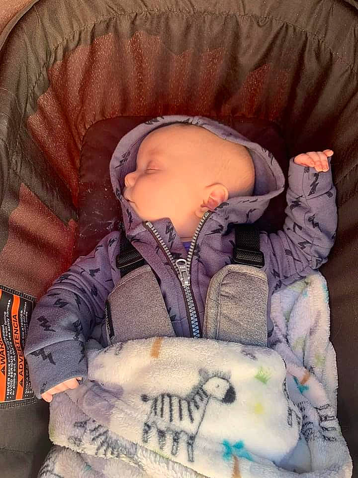 Atreyu is registered to the contest to win money with this photo: baby, baby_products, baby_sleeping, baby_toddler_clothing, cheek, child, comfort, eyelash, hood, jacket, knit_cap, outerwear, pattern, person, product, purple, sitting, sleeve, textile, toddler