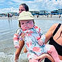 baby, child, adult, beach, water, swimsuit, hat, splashing, summer, sky, clouds, people, vacation, holding, ocean, shore, fun, sunny, outdoor, family