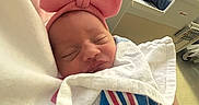 Kylee joined the competition — help win amazing prizes! baby, blanket, care, child, cozy, family, headband, hospital_bed, hospital_blanket, hospital_room, indoor, man, newborn, parent, person, pink_bow, portrait, resting, sleeping, tired