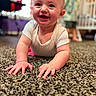 Kylee joined the competition — help win amazing prizes! baby, crawling, carpet, onesie, toddler, crib, indoor, child, happy, smiling, person, floor, home, furniture, blurred_background, blue_eyes, skin, hands, head, cute