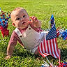 Zion joined the competition — help win amazing prizes! american_flag, baby, celebration, child, crawling, curious, face, festive_decorations, grass, hands, infant, lawn, outdoor, overalls, patriotic, portrait, reaching, red_white_blue, smiling, sunlight