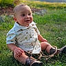 baby, button_up_shirt, child, cowboy_boots, face, garden, grass, greenery, happy, infant, nature, outdoor, patterned_clothing, person, portrait, rope, rural, sitting, smiling, sunlight