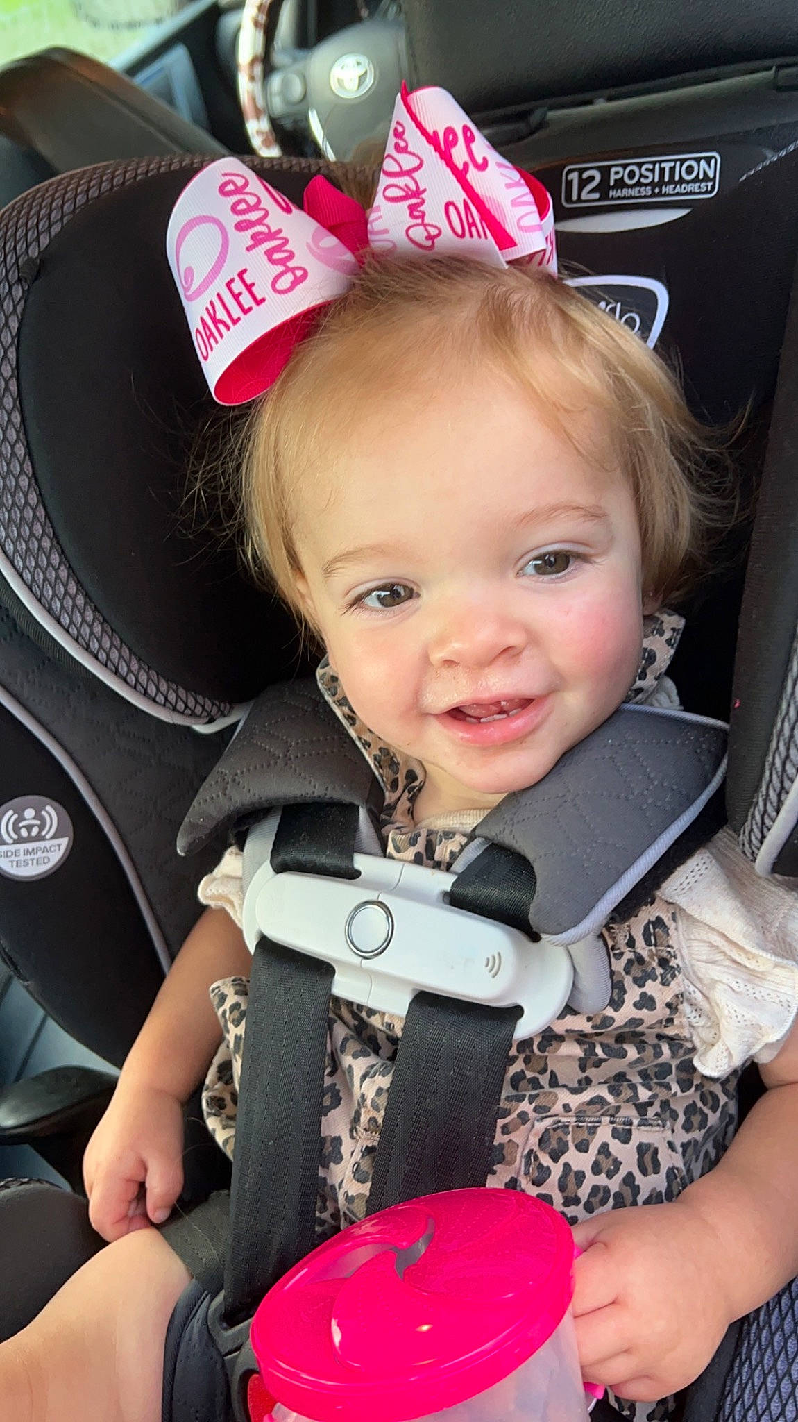 Oaklee is registered to the contest to win money with this photo: auto_part, baby, baby_carriage, baby_products, baby_toddler_clothing, blond, car_seat, cheek, child, event, fashion_accessory, fun, happy, joy, person, personal_protective_equipment, pink, product, seat_belt, skin