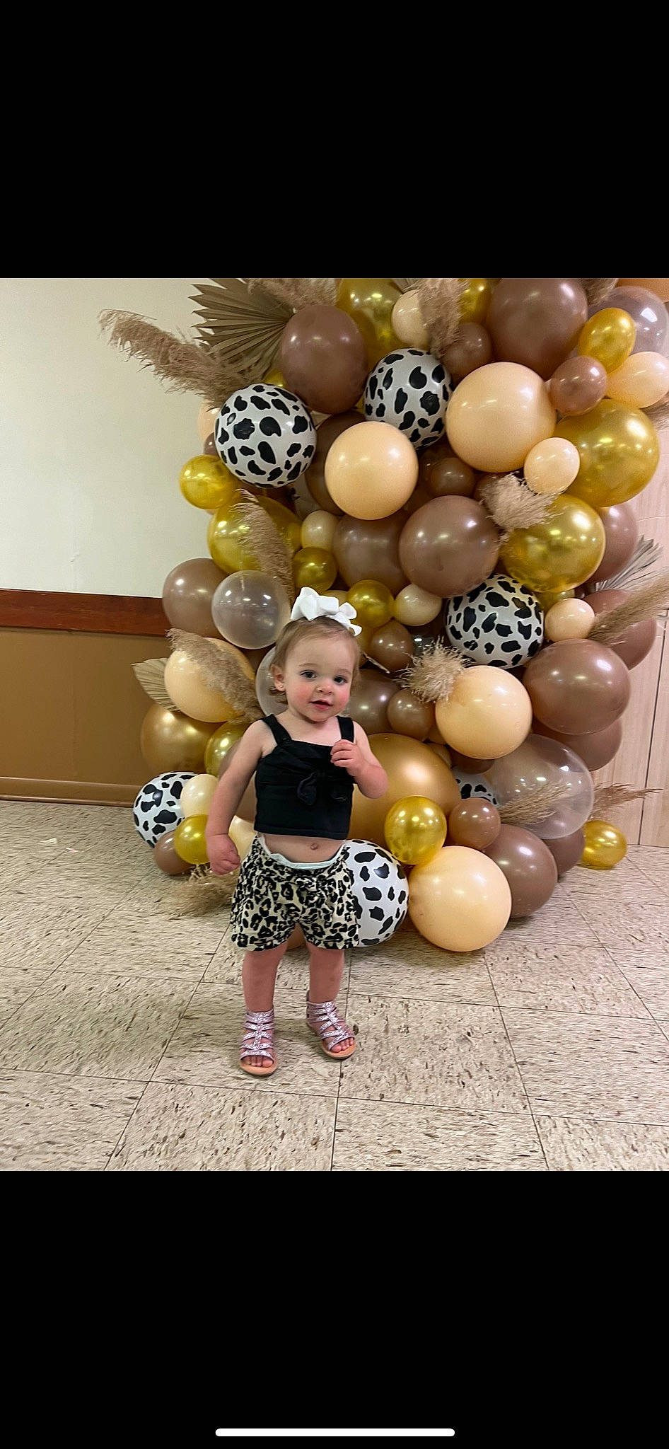 Oaklee is registered to the contest to win money with this photo: arch, art, baby, balloon, child, event, fashion_accessory, flooring, fun, happy, leg, leisure, party_supply, person, recreation, sandal, sitting, toddler, toy, visual_arts