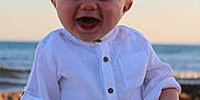 Louka participe au concours pour gagner de l'argent avec cette photo : baby, beach, casual, child, cute, happy, infant, nature, ocean, outdoor, portrait, sand, sitting, smiling, sunlight, sunset, vacation, waves, white_shirt, young_child