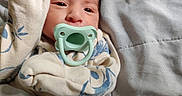 Rafael is registered to the contest to win money with this photo: baby, bed, blanket, child, clothing, comfort, cozy, cute, face, hand, indoor, infant, newborn, onesie, pacifier, pattern, portrait, resting, sleeping, soft