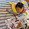 baby, blanket, child, colorful, cozy, cute, face, hand, indoors, infant, nursery, pacifier, patterned, peaceful, pillow, resting, sleeping, soft_toys, striped_bedspread, wrapped