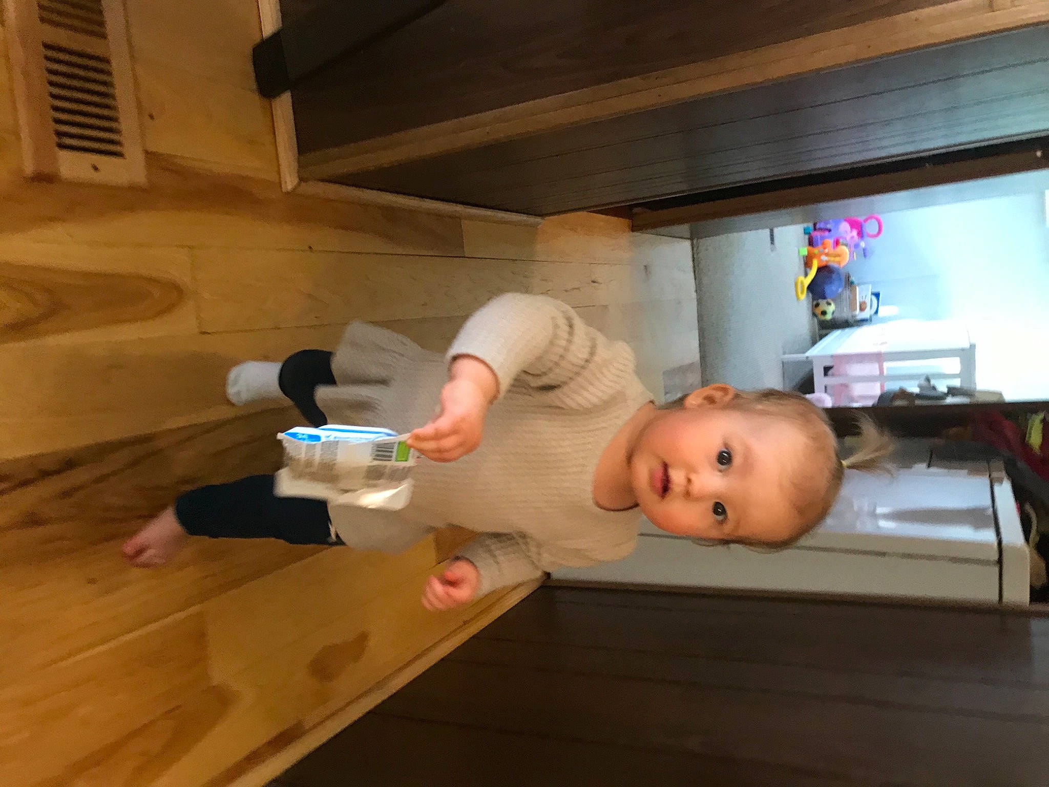 Mila is registered to the contest to win money with this photo: baby, baby_products, bed, comfort, floor, flooring, fun, hardwood, home_appliance, kitchen, person, room, shelf, television, toddler, wood, wood_flooring, wood_stain