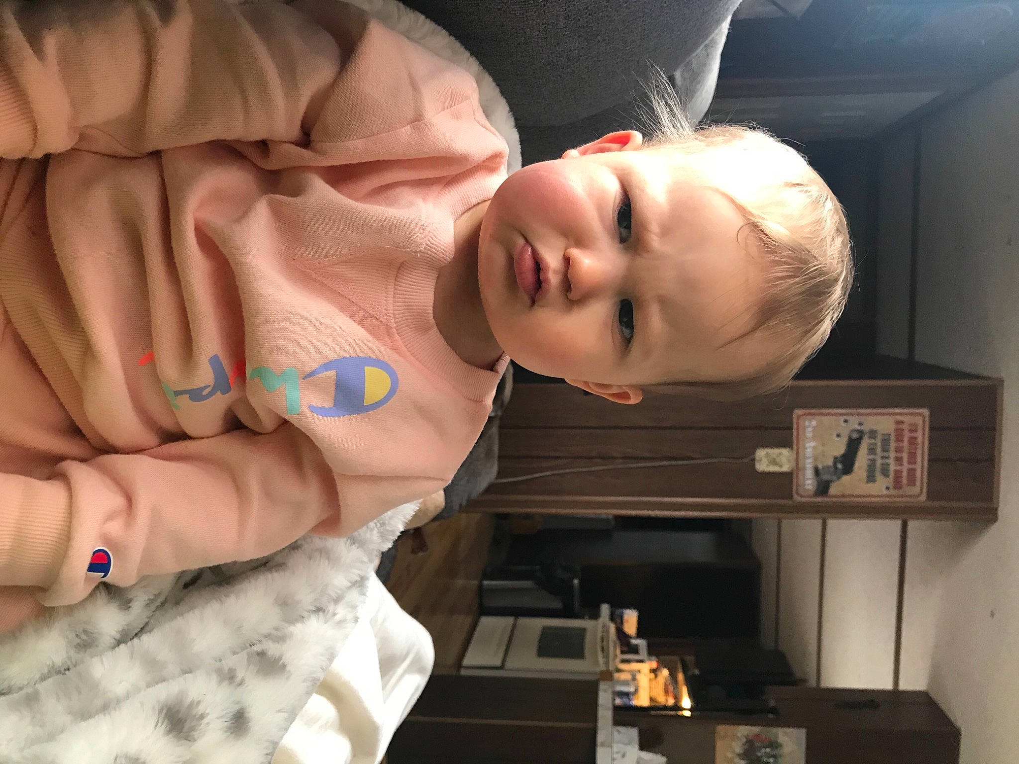 Mila is registered to the contest to win money with this photo: baby, cheek, comfort, eye, eyelash, face, finger, flash_photography, fun, gesture, hair, human_body, jaw, mouth, neck, nose, person, sleeve, thumb, toddler