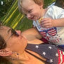 adult, celebration, child, clothing, cracker, earrings, face, family, glasses, grass, happy, nature, outdoor, park, patriotic, person, smile, summer, sunlight, toddler