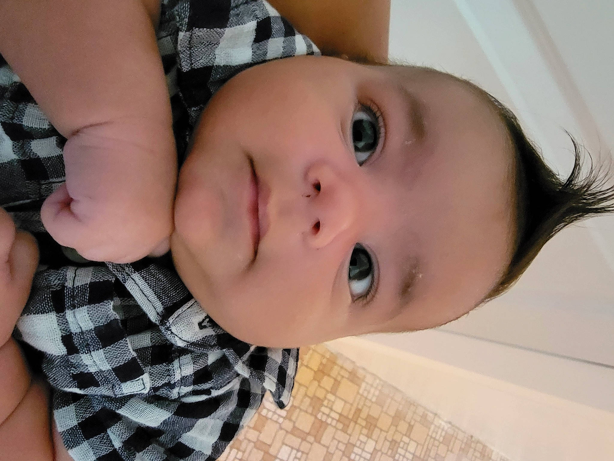 Gael is registered to the contest to win money with this photo: baby, baby_toddler_clothing, cheek, child, dress_shirt, eyebrow, eyelash, happy, iris, lip, mouth, neck, nose, pattern, person, plaid, plant, skin, tartan, throat