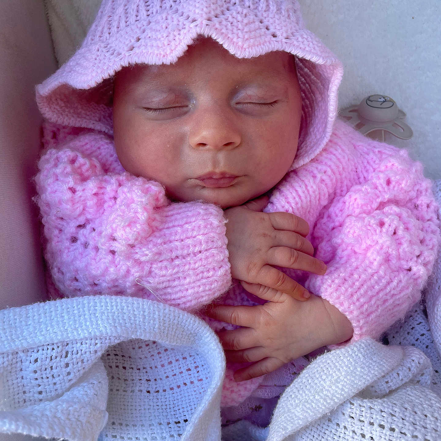 Ida is registered to the contest to win money with this photo: baby, blanket, child, closeup, cozy, cute, face, hands, hat, indoors, infant, knitted, newborn, pacifier, peaceful, pink, resting, sleeping, soft, sweater