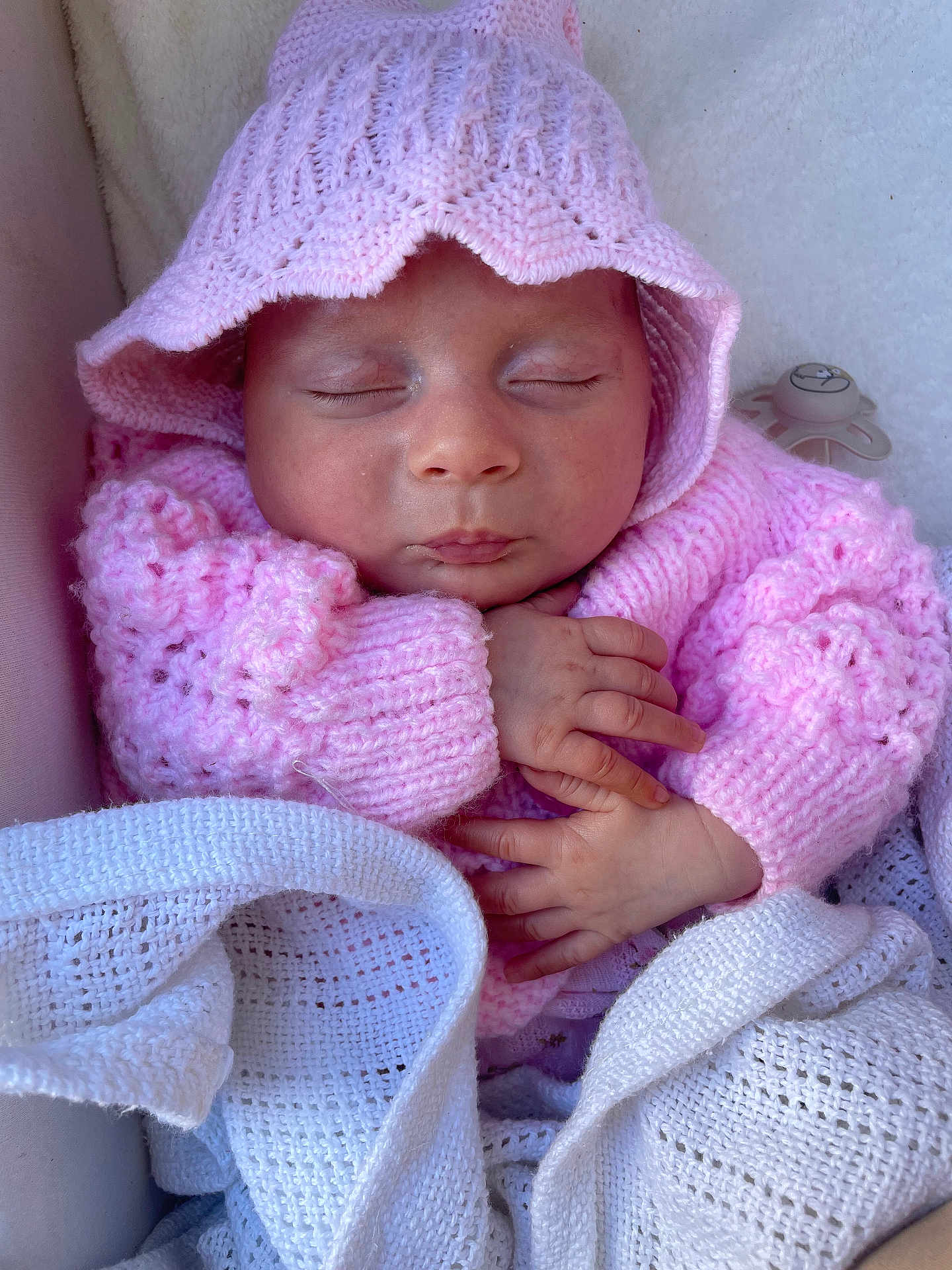 Ida is registered to the contest to win money with this photo: baby, blanket, child, closeup, cozy, cute, face, hands, hat, indoors, infant, knitted, newborn, pacifier, peaceful, pink, resting, sleeping, soft, sweater