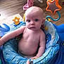 Esther joined the competition — help win amazing prizes! baby, child, infant, blue_eyes, baby_seat, toy, star_toy, hand, floor, wooden_floor, indoor, person, skin, arm, face, expression, sitting, cute, young, playtime