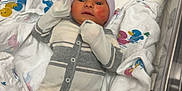 Maximus joined the competition — help win amazing prizes! newborn, baby, hospital, bassinet, blanket, onesie, hat, foot, fist, face, infant, sleepwear, hospital_room, crib, colorful, pattern, duck, medical, pacifier, cute
