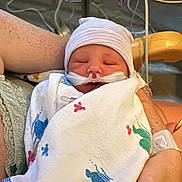Maximus joined the competition — help win amazing prizes! newborn, baby, hospital, blanket, hat, medical_tubes, person, arm, skin, freckles, hospital_bed, hospital_equipment, resting, sleeping, infant, closeup, care, healthcare, patient, wrapped