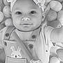 baby, child, headband, smile, overalls, bunny_design, toy, playful, lying_down, closeup, monochrome, cute, infant, soft_texture, rounded_objects, adorable, portrait, toddler, hand, baby_clothes