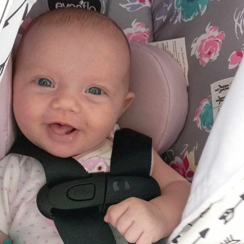 Brooke joined the competition — help win amazing prizes! baby, blanket, canopy, car_seat, child, clothing, comfort, cute, fabric, face, floral, happy, head, indoors, infant, pacifier, pattern, person, smiling, straps