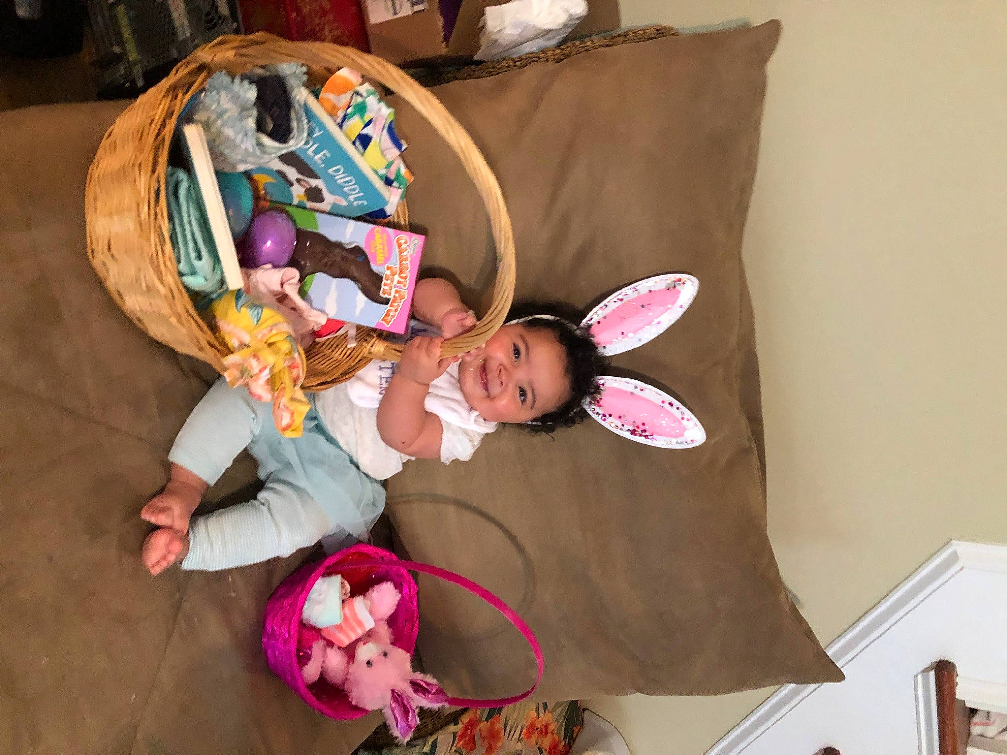 Kennedi is registered to the contest to win money with this photo: baby, baby_toddler_clothing, child, comfort, couch, event, flooring, fun, happy, joy, linens, magenta, person, pillow, pink, play, room, sitting, smile, throw_pillow