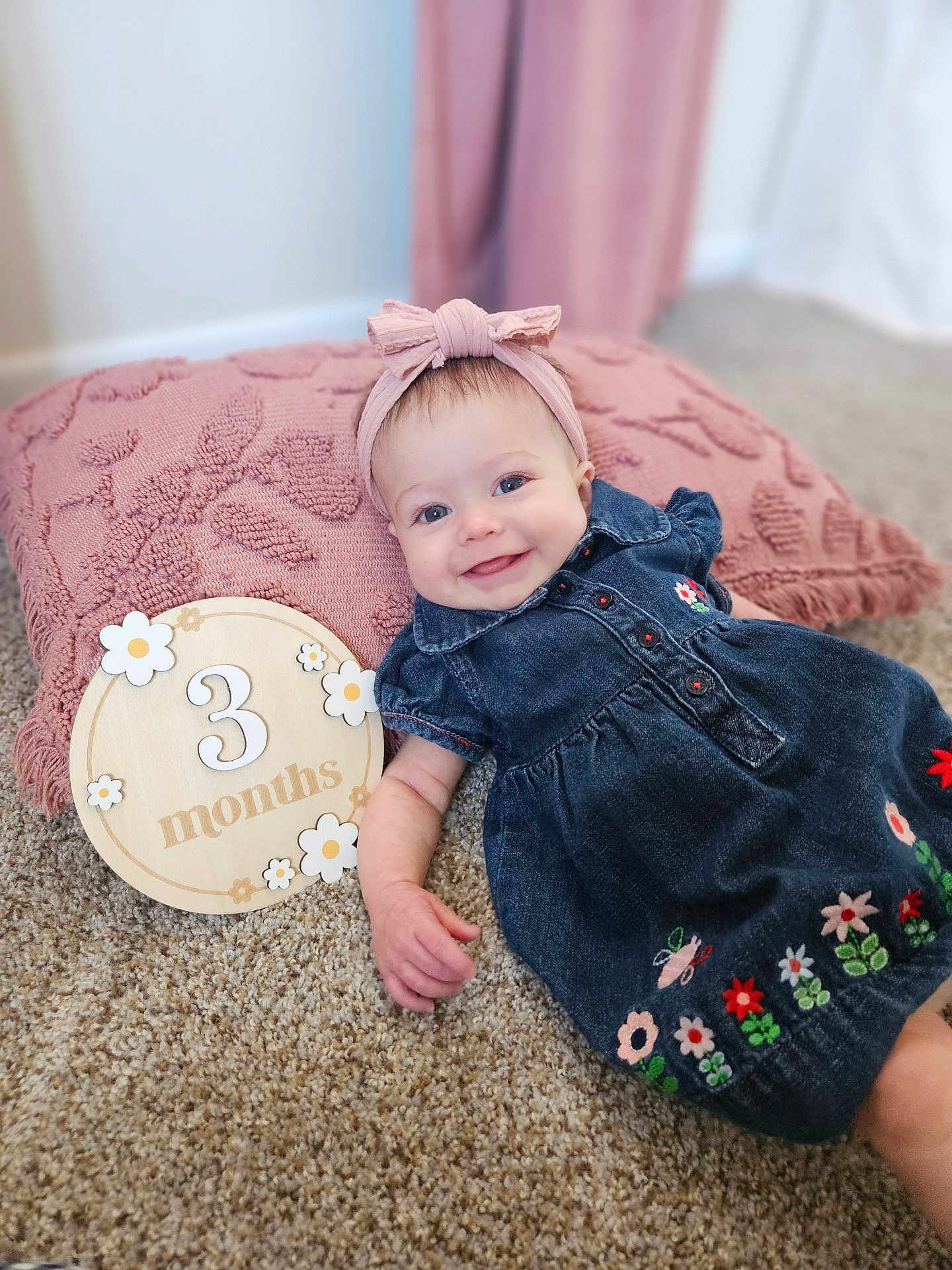 Alethea joined the competition — help win amazing prizes! baby, infant, smiling, denim_dress, headband, pink_pillow, carpet, milestone, 3_months, wooden_plaque, flowers, embroidery, cute, happy, lying_down, indoors, child, portrait, decor, soft_texture