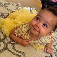 Venera joined the competition — help win amazing prizes! baby, child, yellow_dress, tutu, smile, face, eyes, carpet, pattern, indoor, cute, curly_hair, sneakers, floor, infant, playful, person, toddler, happy, clothing